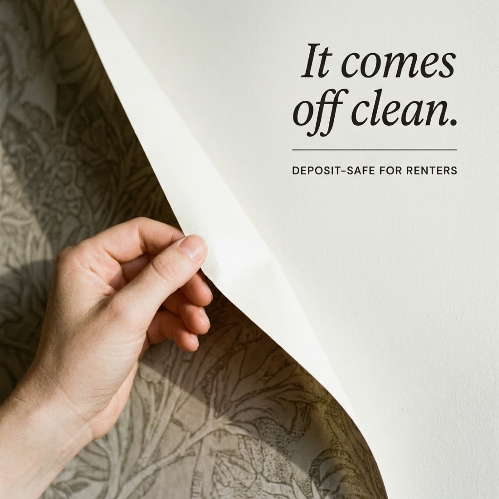 Hand peeling wallpaper cleanly off a wall with renter-safe overlay